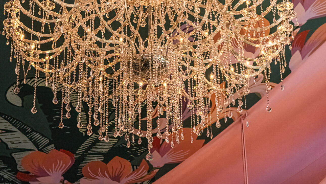 The exclusive amfAR Palm Beach Gala event seated gala dinner with stunning tent featuring custom fabric draped among crystal chandeliers. Event designed by  JWennes Events.