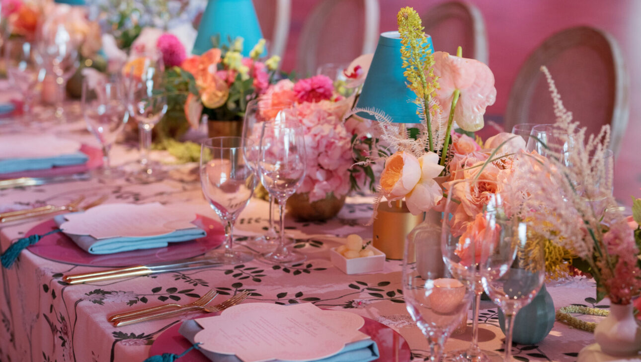 Extravagant wedding reception table decor with custom floral linens. Designed by  JWennes Events.